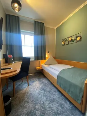 Ein Bett oder Betten in einem Zimmer der Unterkunft Hotel Louis Müller