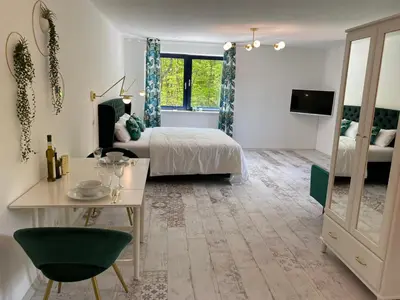 Ein Bett oder Betten in einem Zimmer der Unterkunft Ferienwohnungen Park Café am Kurpark