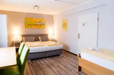 Ein Bett oder Betten in einem Zimmer der Unterkunft Schroeders Stadtwaldhotel