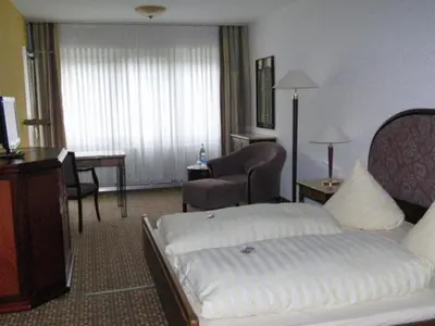 Ein Bett oder Betten in einem Zimmer der Unterkunft Hotel Moselkern