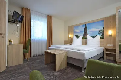 Ein Bett oder Betten in einem Zimmer der Unterkunft DORMERO Moselhotel Koblenz-Alken