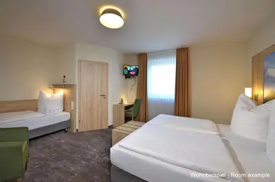 Ein Bett oder Betten in einem Zimmer der Unterkunft DORMERO Moselhotel Koblenz-Alken