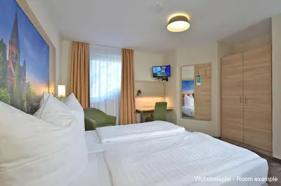 Ein Bett oder Betten in einem Zimmer der Unterkunft DORMERO Moselhotel Koblenz-Alken