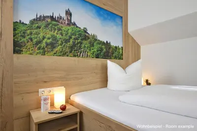 Ein Bett oder Betten in einem Zimmer der Unterkunft DORMERO Moselhotel Koblenz-Alken