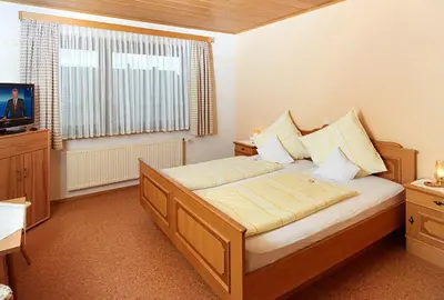 Ein Bett oder Betten in einem Zimmer der Unterkunft Hotel Garni Assion