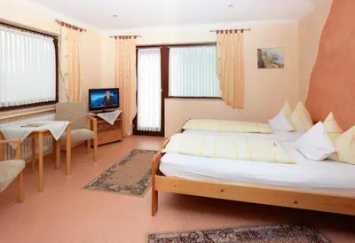 Ein Bett oder Betten in einem Zimmer der Unterkunft Hotel Garni Assion