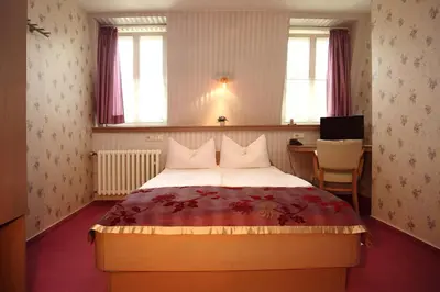 Ein Bett oder Betten in einem Zimmer der Unterkunft Astoria Hotel