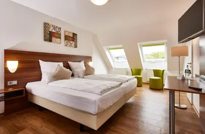 Ein Bett oder Betten in einem Zimmer der Unterkunft ante porta DAS STADTHOTEL