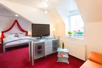 Ein Bett oder Betten in einem Zimmer der Unterkunft Moselromantik-Hotel zum Löwen