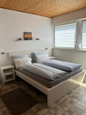Ein Bett oder Betten in einem Zimmer der Unterkunft Haus Rheinterrasse