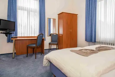 Ein Bett oder Betten in einem Zimmer der Unterkunft Golfhotel Denzerheide