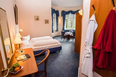 Ein Bett oder Betten in einem Zimmer der Unterkunft Golfhotel Denzerheide
