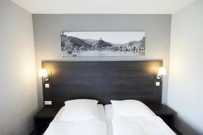 Ein Bett oder Betten in einem Zimmer der Unterkunft aparthotel Cochem