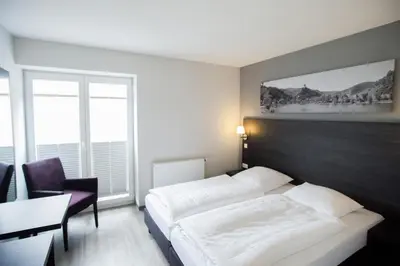Ein Bett oder Betten in einem Zimmer der Unterkunft aparthotel Cochem