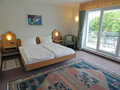 Ein Bett oder Betten in einem Zimmer der Unterkunft Hotel garni Am Brunnenplatz