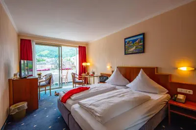 Ein Bett oder Betten in einem Zimmer der Unterkunft Moselstern Hotel Brixiade &Triton