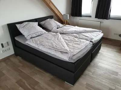 Ein Bett oder Betten in einem Zimmer der Unterkunft Beim Hooch 