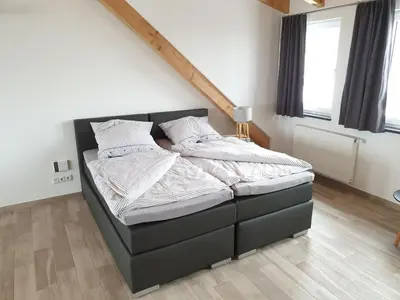 Ein Bett oder Betten in einem Zimmer der Unterkunft Beim Hooch 
