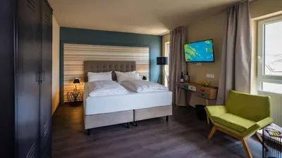 Ein Bett oder Betten in einem Zimmer der Unterkunft Hotel Goldene Traube - by Neugart