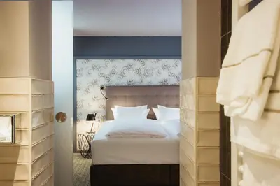 Ein Bett oder Betten in einem Zimmer der Unterkunft Hotel Goldene Traube - by Neugart