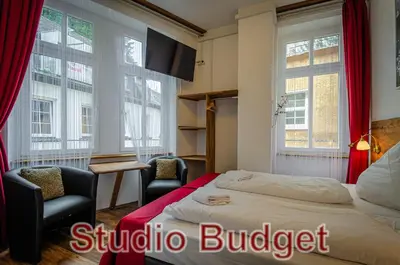 Ein Bett oder Betten in einem Zimmer der Unterkunft MoselUnion - Aparthotel Landsknecht