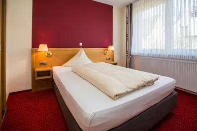 Ein Bett oder Betten in einem Zimmer der Unterkunft Hotel Merle