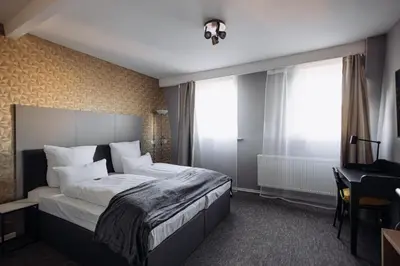 Ein Bett oder Betten in einem Zimmer der Unterkunft Hotel Kleiner Riesen