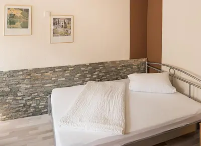 Ein Bett oder Betten in einem Zimmer der Unterkunft Gästezimmer Strauß