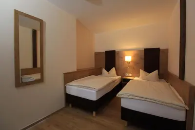 Ein Bett oder Betten in einem Zimmer der Unterkunft Waldhotel Albachmühle