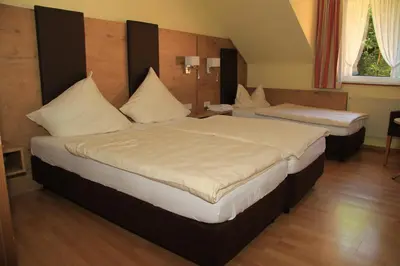 Ein Bett oder Betten in einem Zimmer der Unterkunft Waldhotel Albachmühle