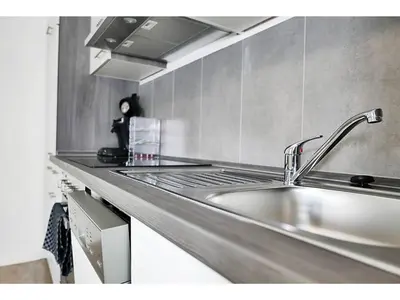Küche/Küchenzeile in der Unterkunft Pitlane Apartments am Brünnchen
