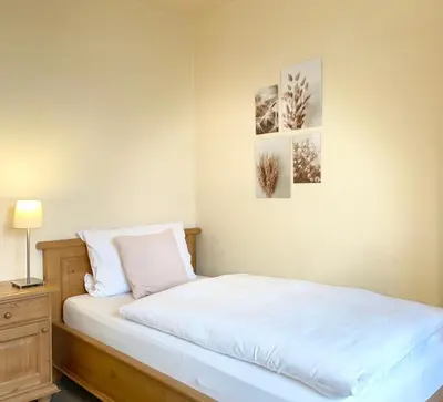 Ein Bett oder Betten in einem Zimmer der Unterkunft Hotel-Pension Hommen