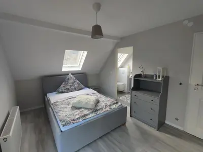 Ein Bett oder Betten in einem Zimmer der Unterkunft Gästehaus Voyage