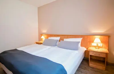 Ein Bett oder Betten in einem Zimmer der Unterkunft Landhotel Ringelsteiner Mühle
