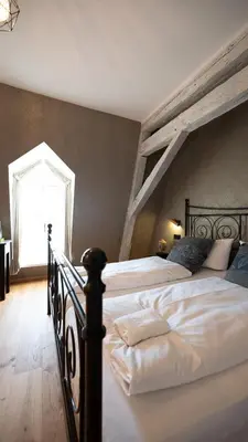 Ein Bett oder Betten in einem Zimmer der Unterkunft Boutiquehotel Kloster Pfalzel