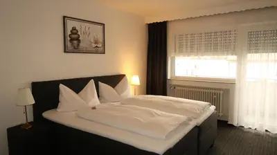 Ein Bett oder Betten in einem Zimmer der Unterkunft Hotel Zur Kripp