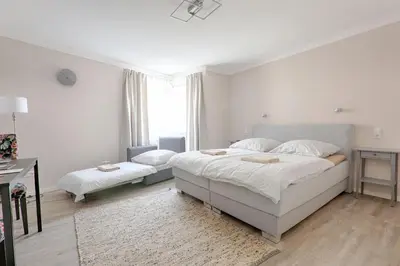 Ein Bett oder Betten in einem Zimmer der Unterkunft H-Apartments