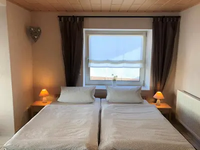 Ein Bett oder Betten in einem Zimmer der Unterkunft Gästehaus Doll