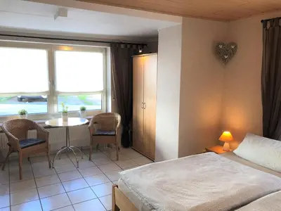 Ein Bett oder Betten in einem Zimmer der Unterkunft Gästehaus Doll