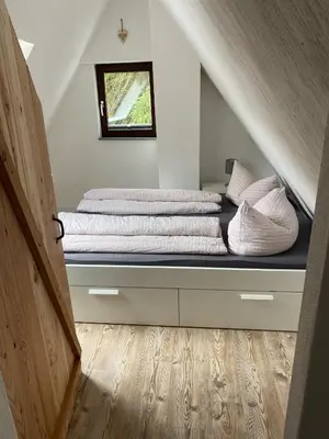 Ein Bett oder Betten in einem Zimmer der Unterkunft Schöne Ferienwohnung Altes Gebälk Fachwerkhaus