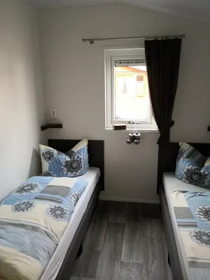 Ein Bett oder Betten in einem Zimmer der Unterkunft Ferienhaus MaLeFi 1 am Gülser Moselbogen