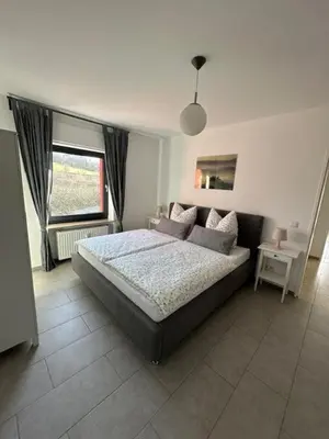 Ein Bett oder Betten in einem Zimmer der Unterkunft Ferienwohnung EIRA