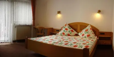 Ein Bett oder Betten in einem Zimmer der Unterkunft Moselhotel Waldeck