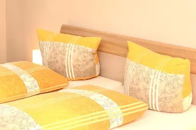 Ein Bett oder Betten in einem Zimmer der Unterkunft Pension / Ferienwohnungen Scheid