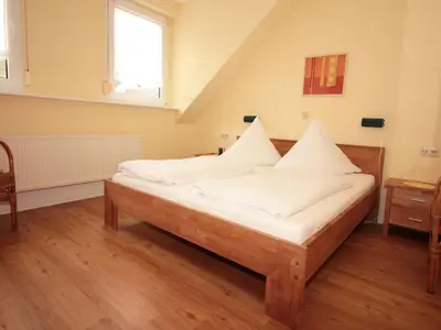 Ein Bett oder Betten in einem Zimmer der Unterkunft Ferienwohnungen Georg Andre Söhne