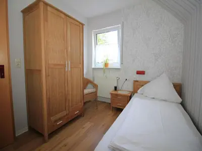 Ein Bett oder Betten in einem Zimmer der Unterkunft Ferienwohnungen Georg Andre Söhne