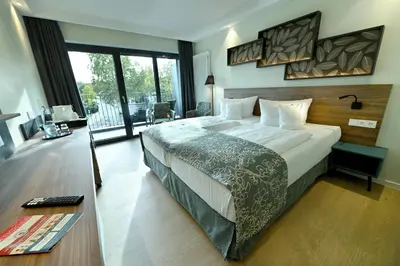 Ein Bett oder Betten in einem Zimmer der Unterkunft Parkhotel 