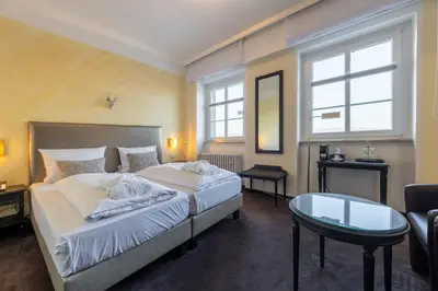 Ein Bett oder Betten in einem Zimmer der Unterkunft Jagdschloss Hotel Niederwald