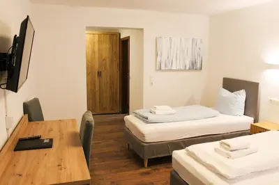 Ein Bett oder Betten in einem Zimmer der Unterkunft Hotel Simonis Koblenz