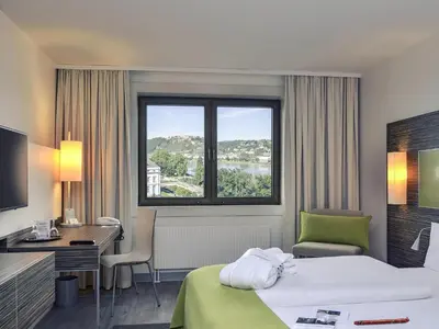 Ein Bett oder Betten in einem Zimmer der Unterkunft Mercure Hotel Koblenz